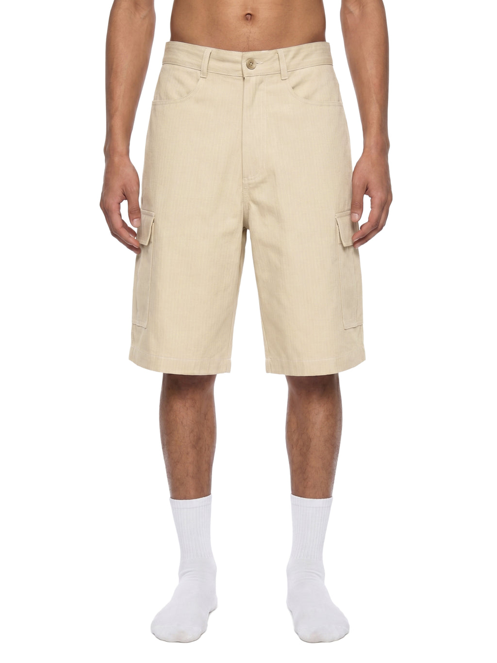 Beige shorts worn by a person on a white background