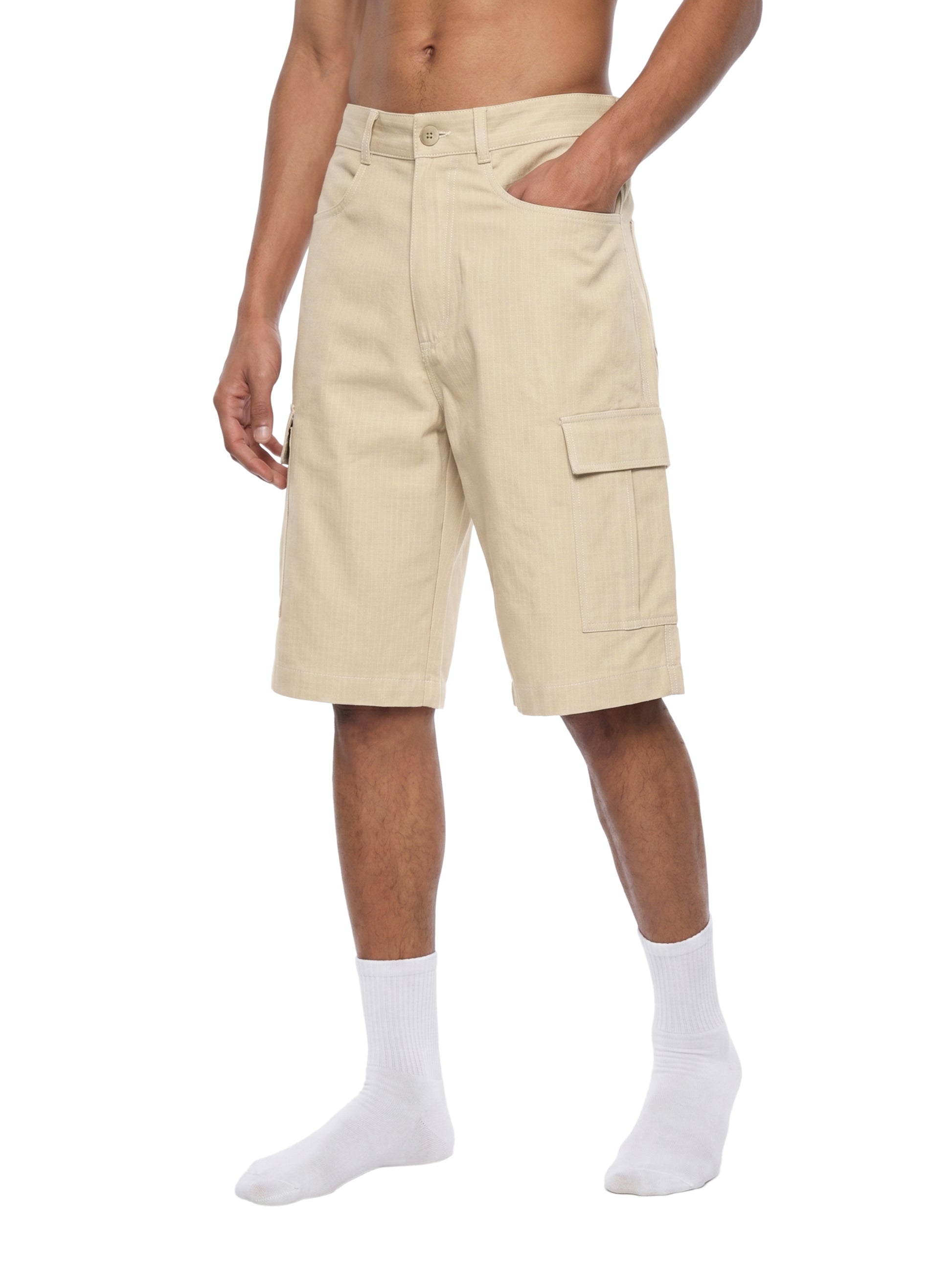 Beige cargo shorts worn by a person on a white background