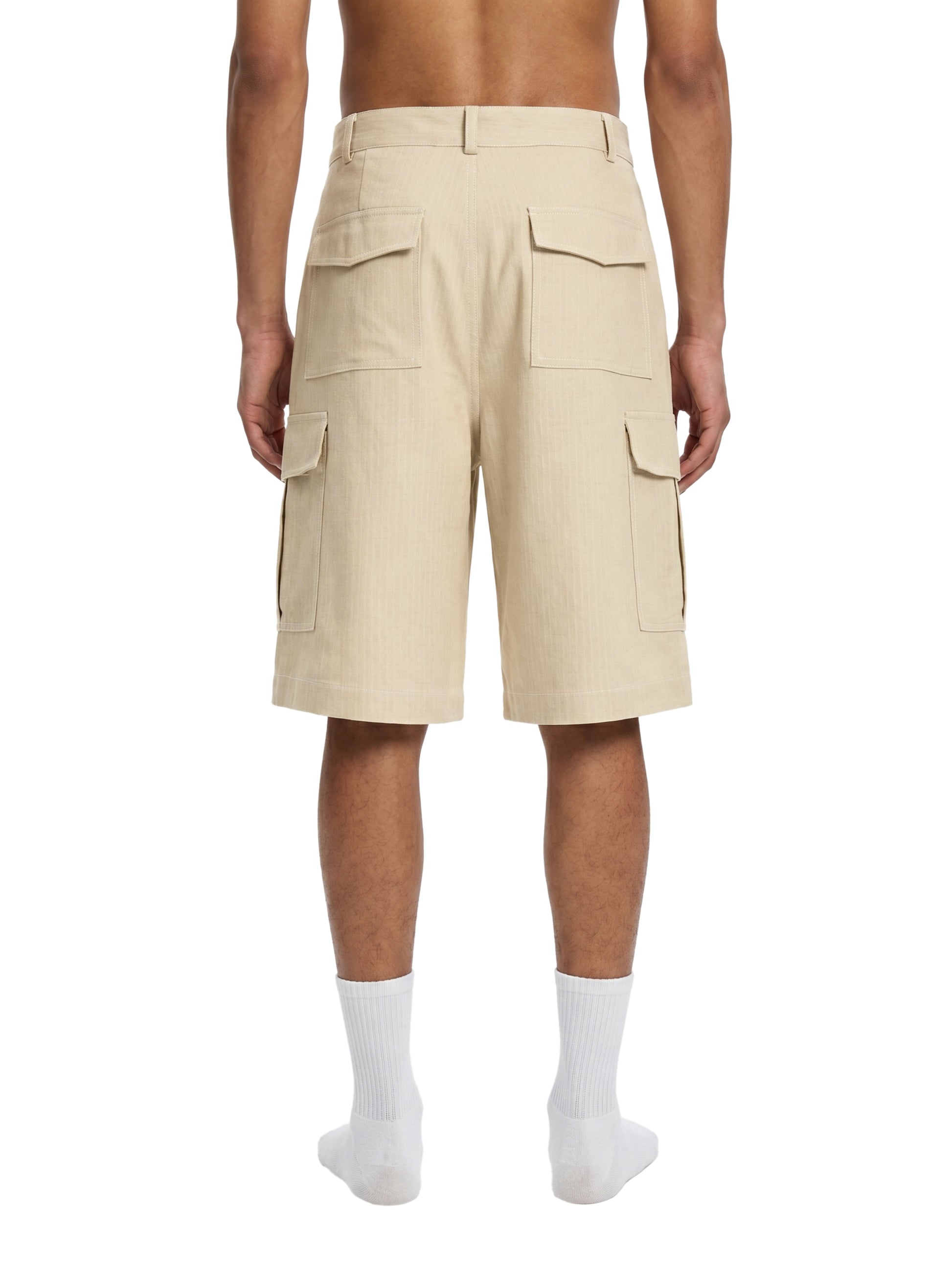 Beige cargo shorts worn by a person on a white background