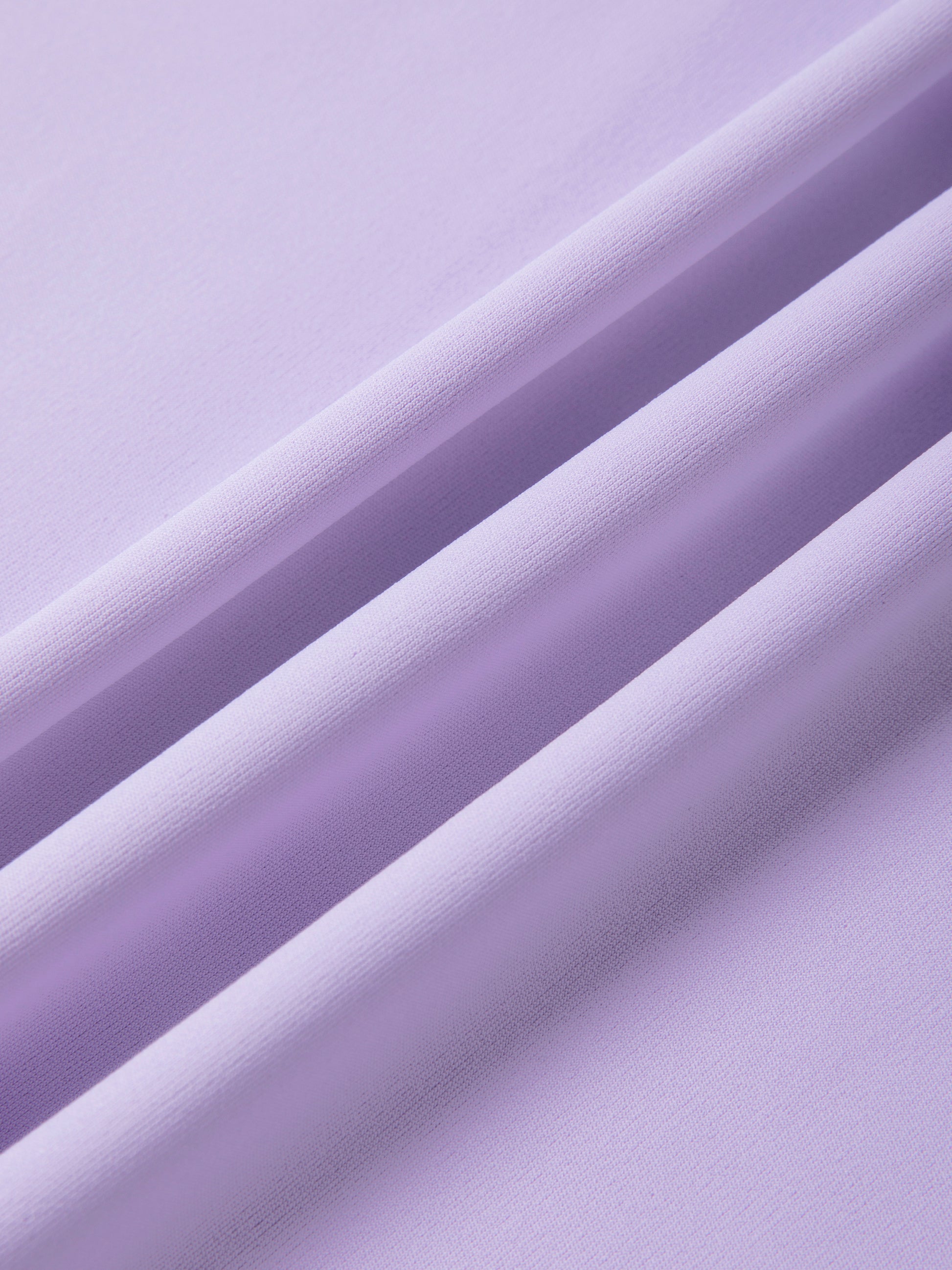 Close-up of light purple fabric with a subtle texture
