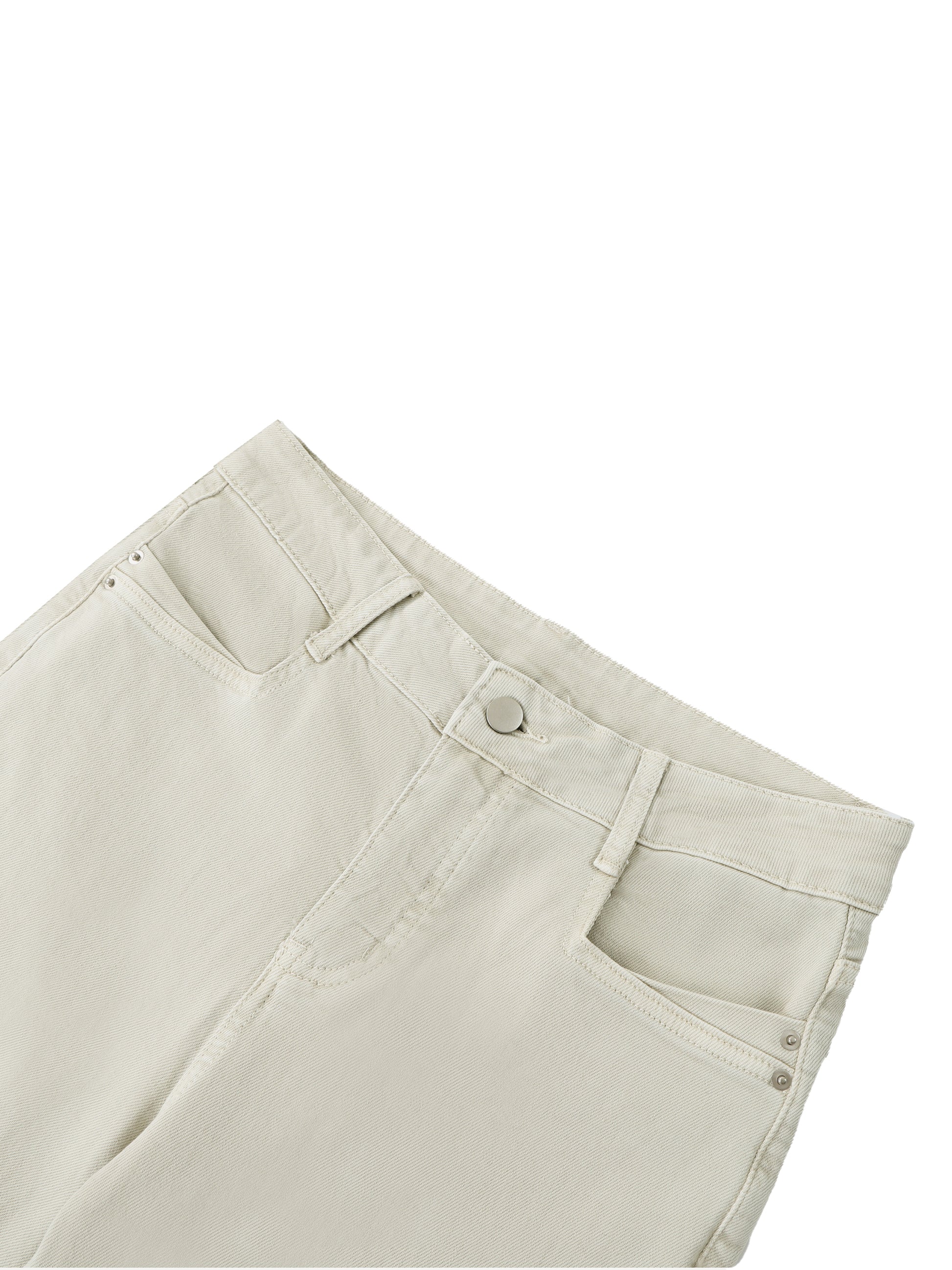 Close-up of light-colored pants on a white background