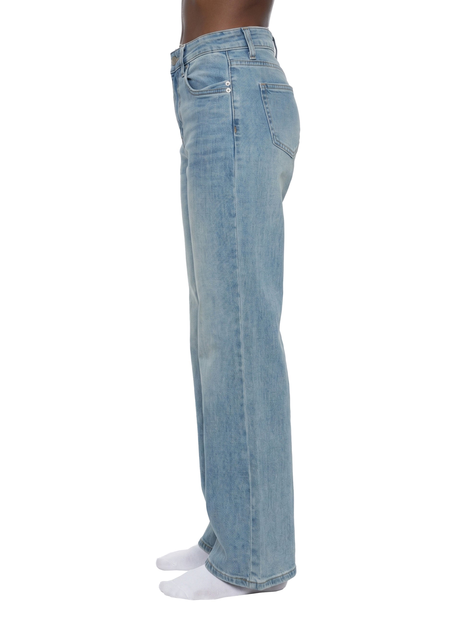 Light blue jeans worn by a person on a white background