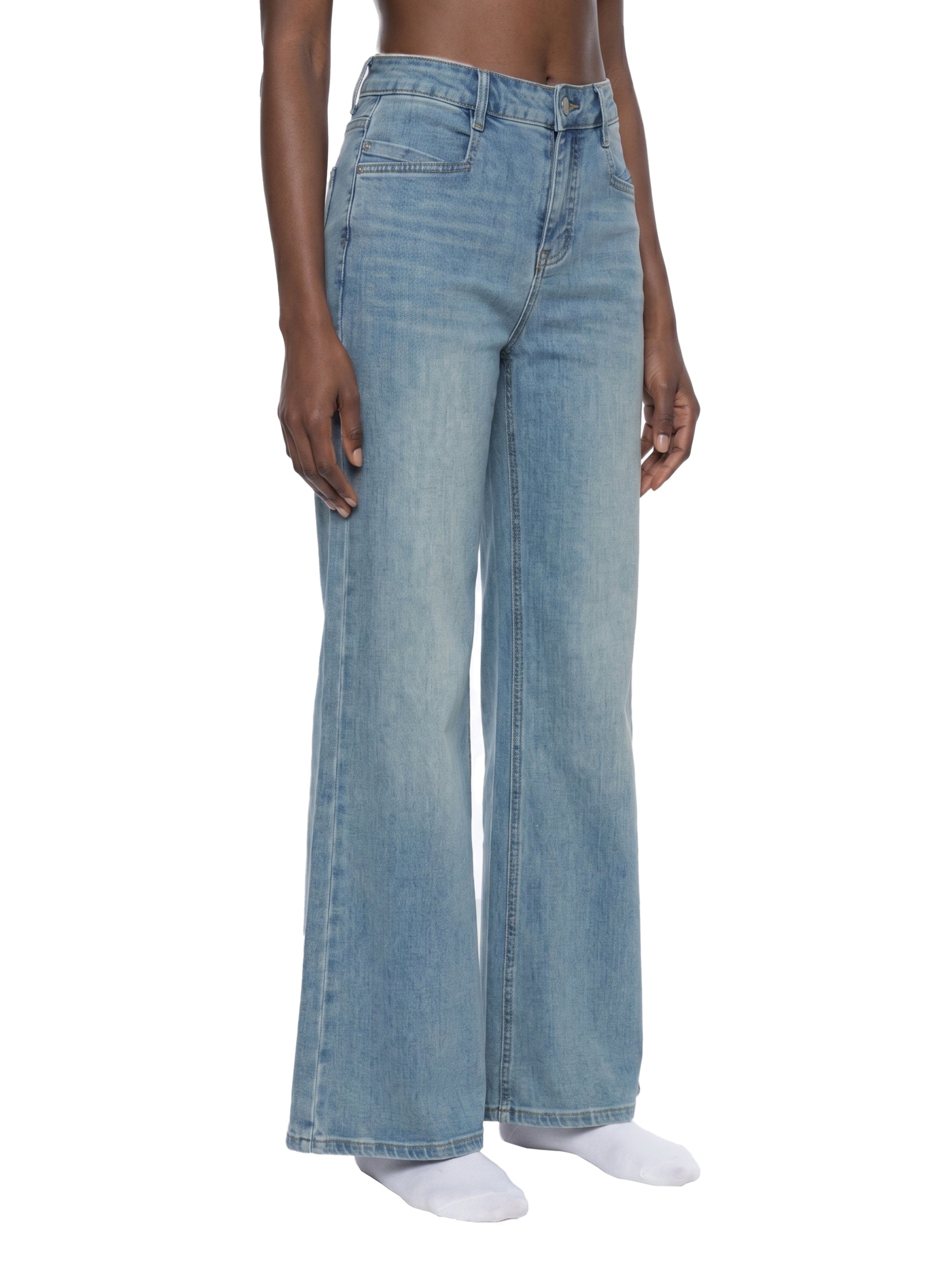 Light blue jeans worn by a person on a white background