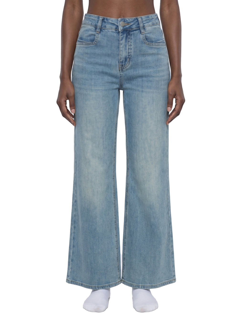 Person wearing light blue jeans on a white background