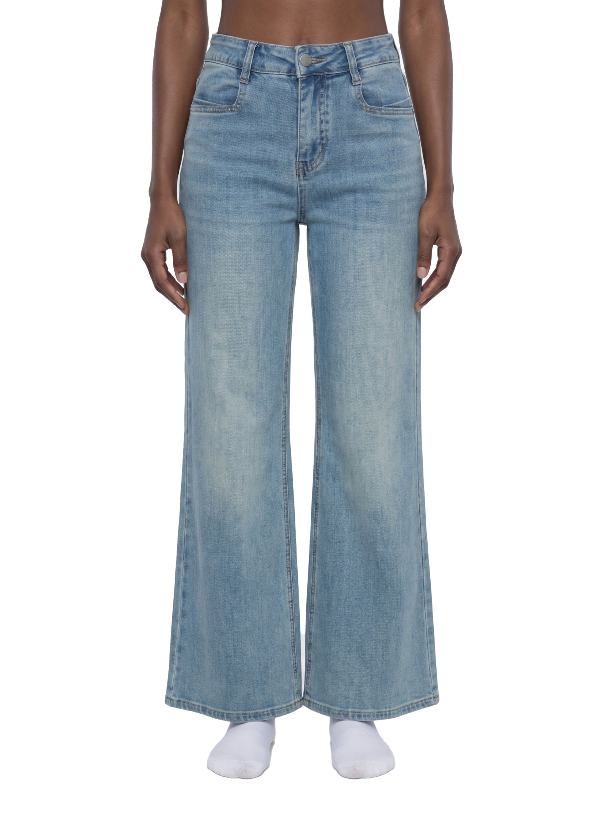 Person wearing light blue jeans on a white background