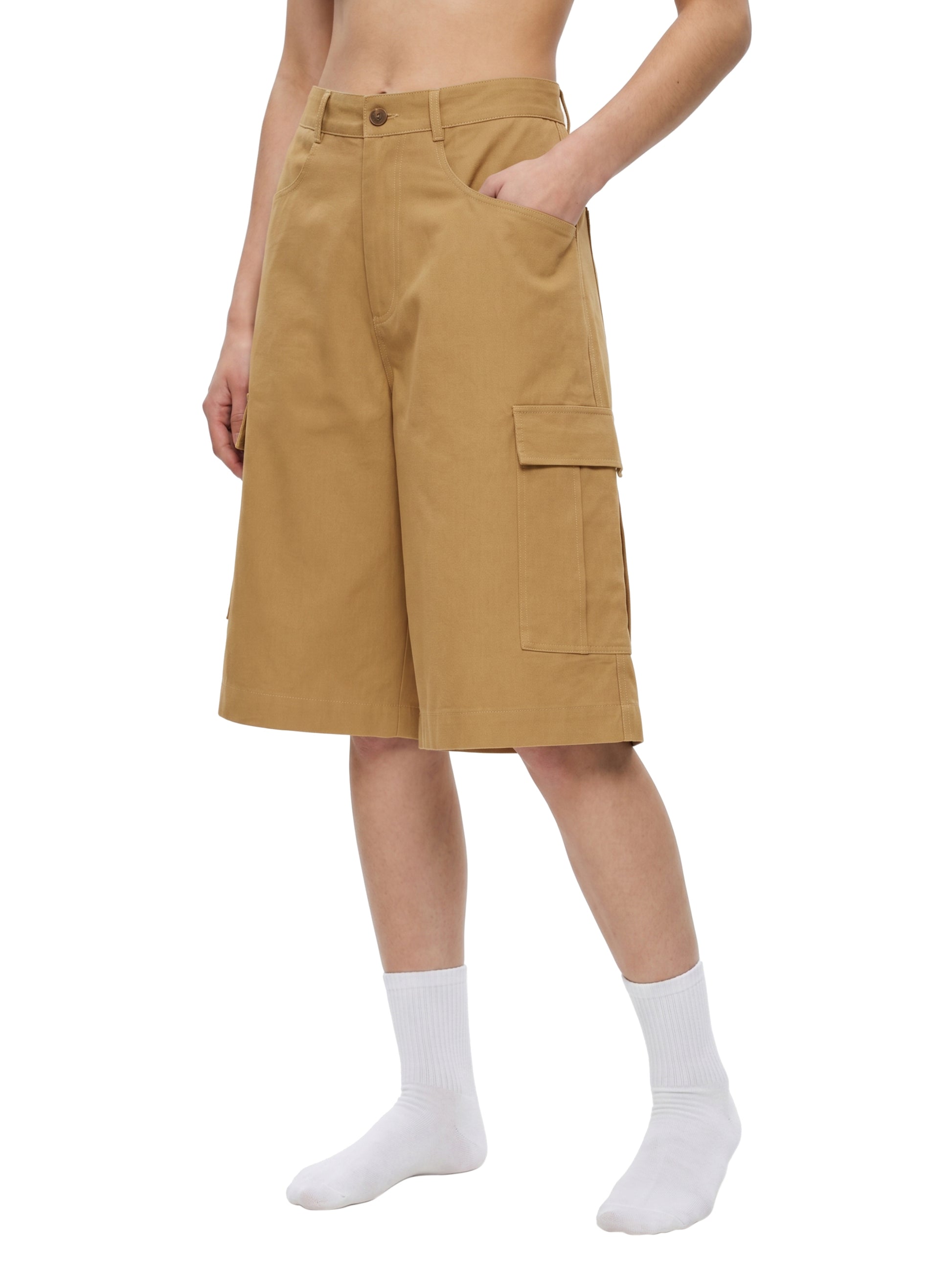 Tan cargo shorts worn by a person on a white background