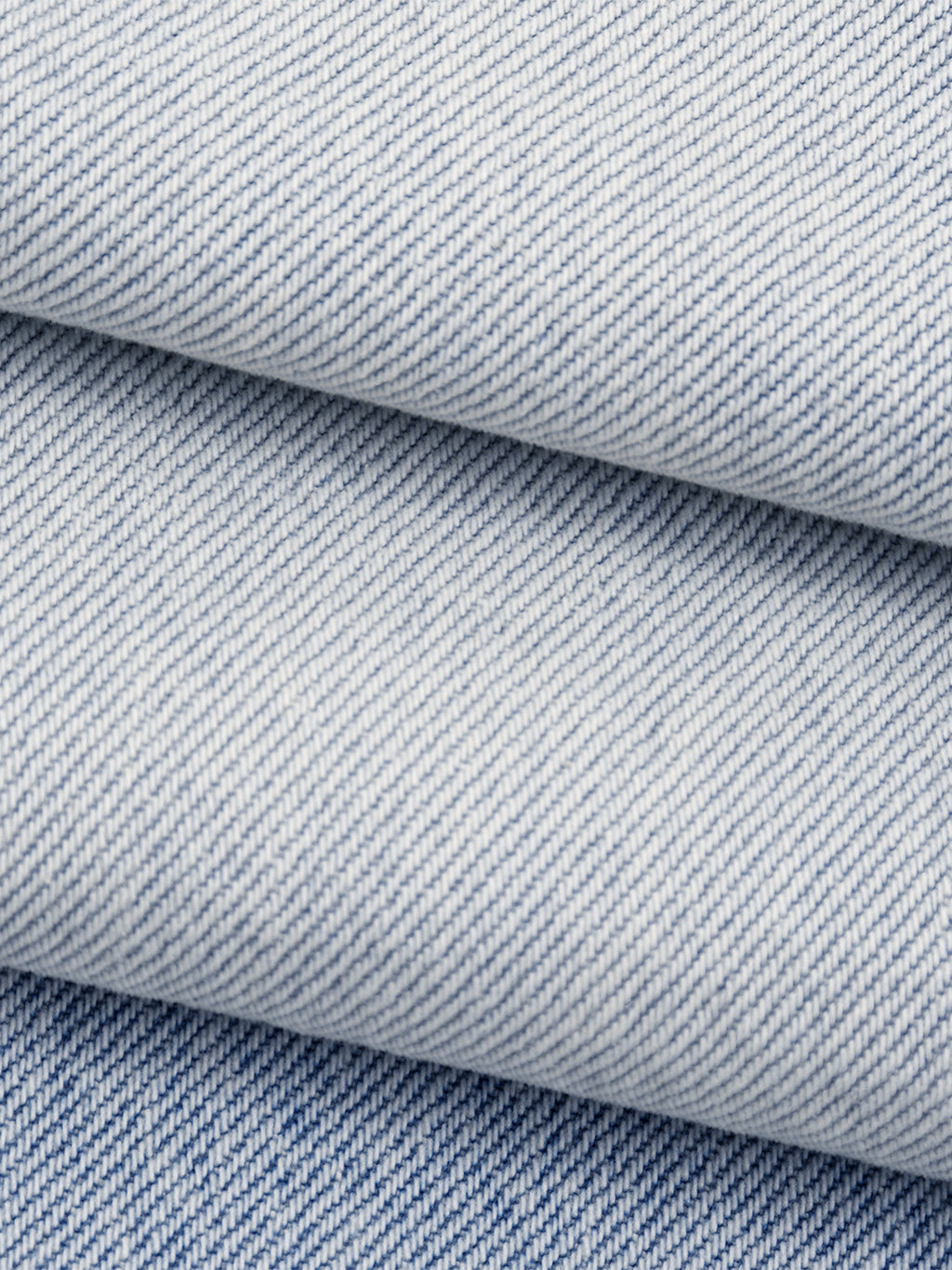 Close-up of blue denim fabric with a subtle pattern