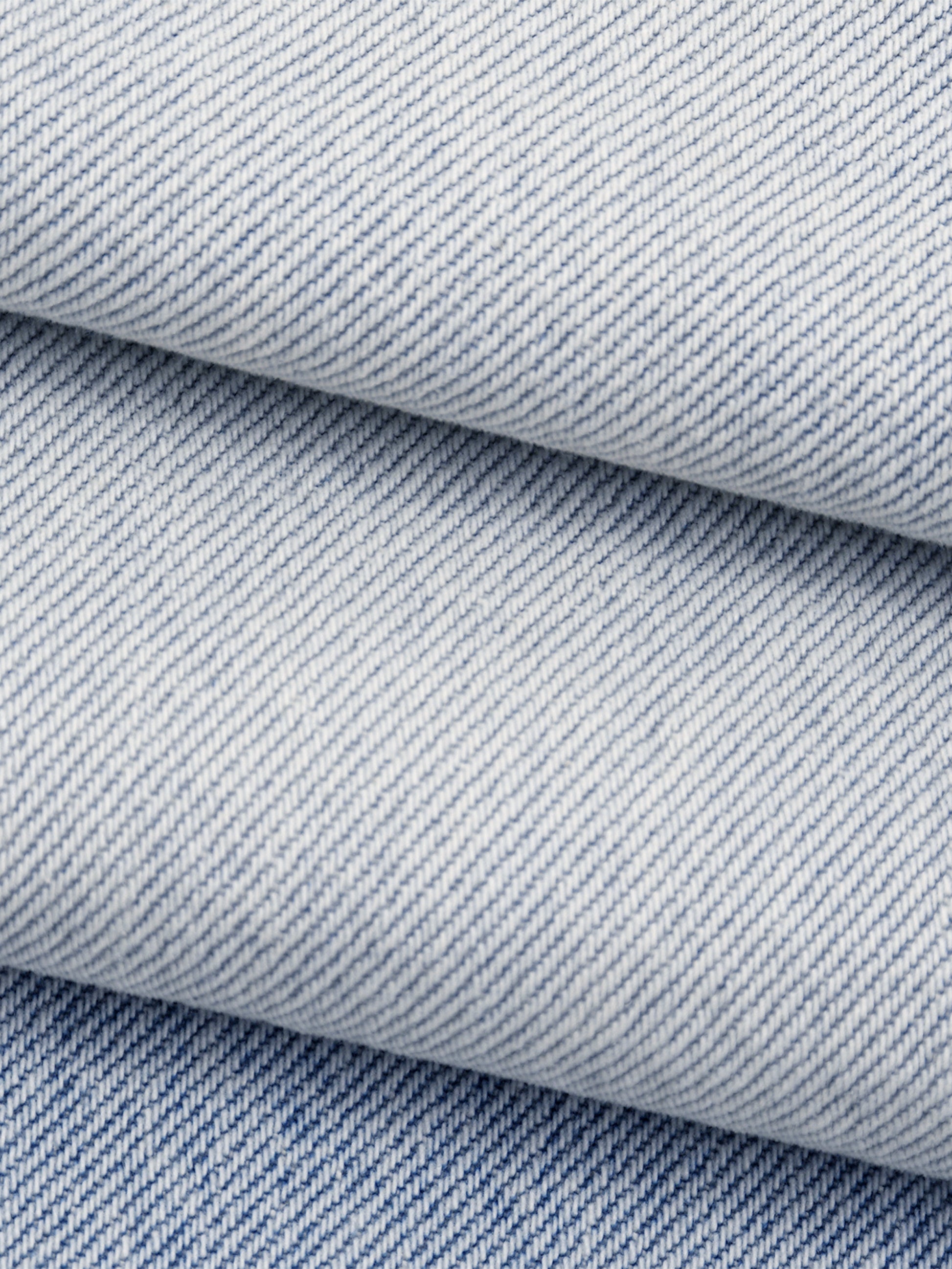 Close-up of blue denim fabric with a subtle pattern