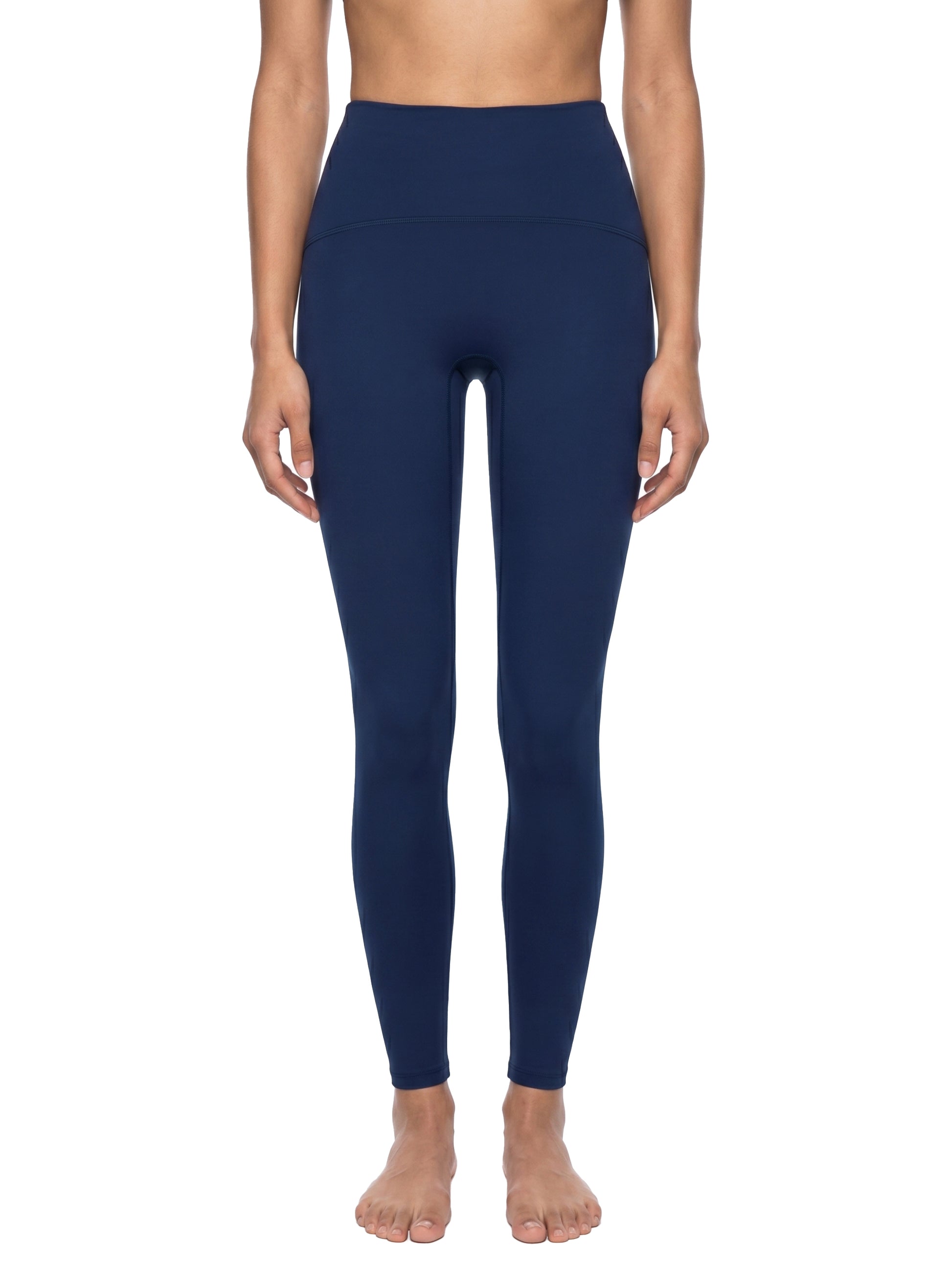 Navy blue leggings worn by a person on a white background
