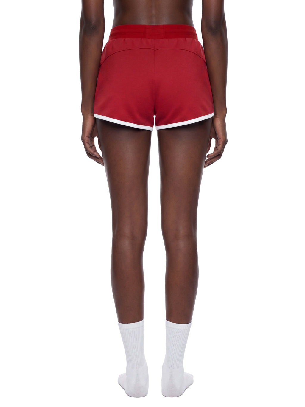 Red athletic shorts worn by a person on a white background