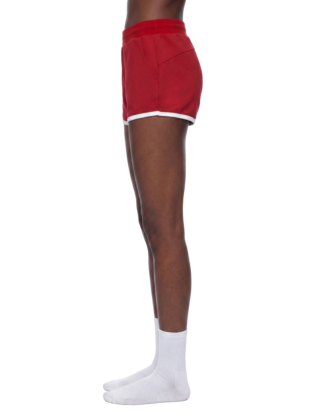 Red shorts worn by a person on a white background